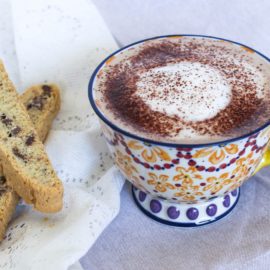 Mocha Latte in a color mug with biscotti