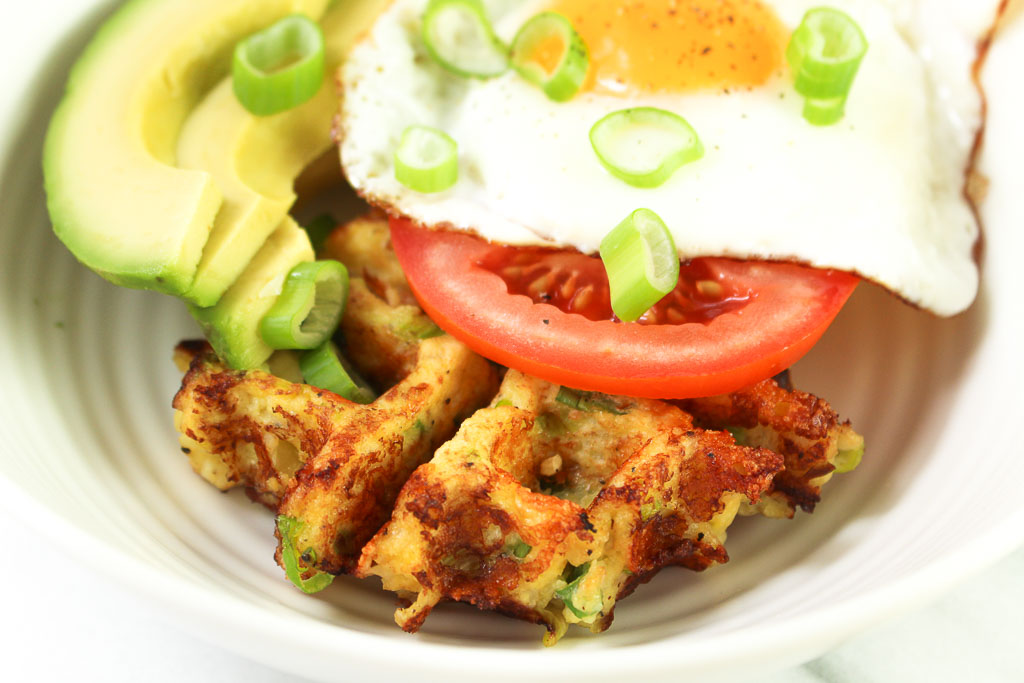 cauliflower waffle with a fried egg, tomato, and avocado