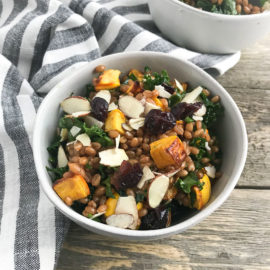 wheat berry salad with squash in a white bowl