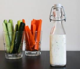 homemade ranch dressing in a glass jar with vegetables
