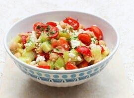 Tomato Cucumber Salad in a white and blue bowl