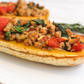 italian stuffed delicata squash on a white plate