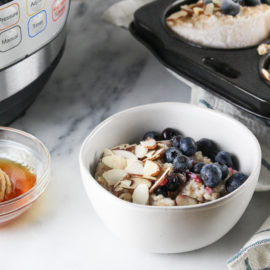 Instant Pot Steel Cut Oats in a white bowl topped with blueberries and almonds