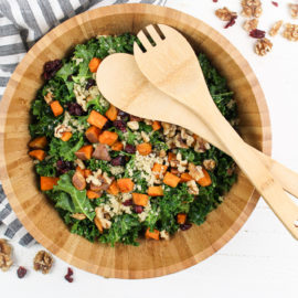 Roasted Sweet Potato Kale Salad in a wooden bowl with wooden utensils