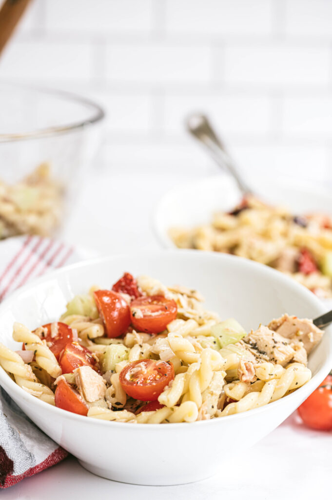 side view of tuna pasta salad in small white bowl