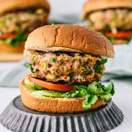 close up of a spinach turkey burger on a bun with lettuce and tomato