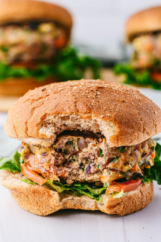 a spinach veggie turkey burger with a bite taken out